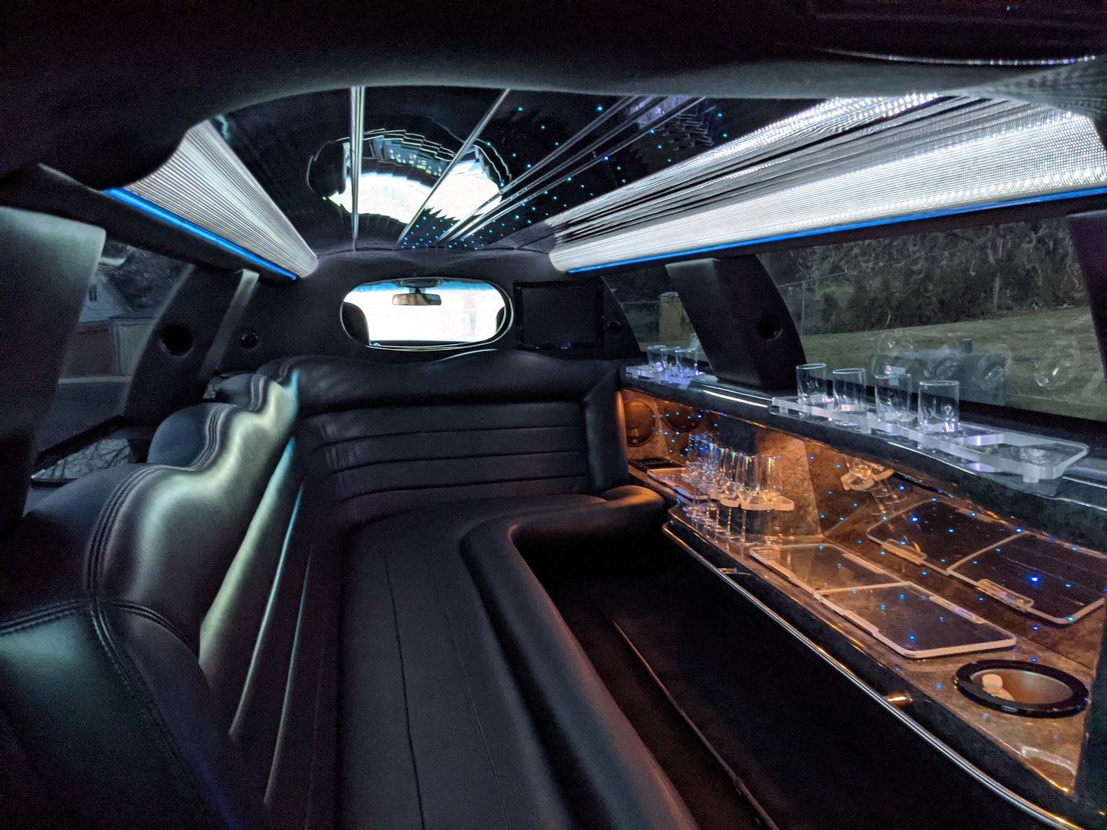 Limo bus interior with green LED lighting and group seating